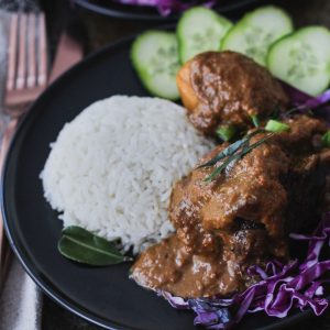 Beef Cheek Rendang served with white rice, sliced cucumbers and shredded red cabbage