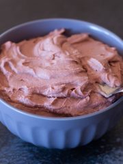 Dairy free strawberry frosting in a bowl, ready to frost some cakes!