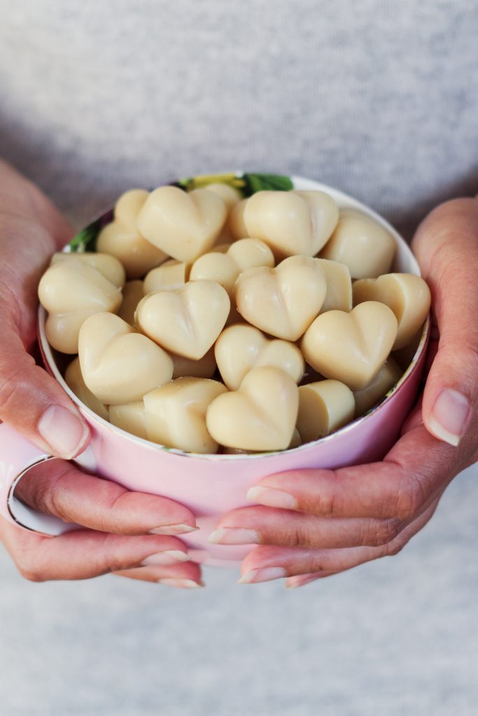 Vegan and Dairy Free white chocolate in heart shapes served in a large teacup