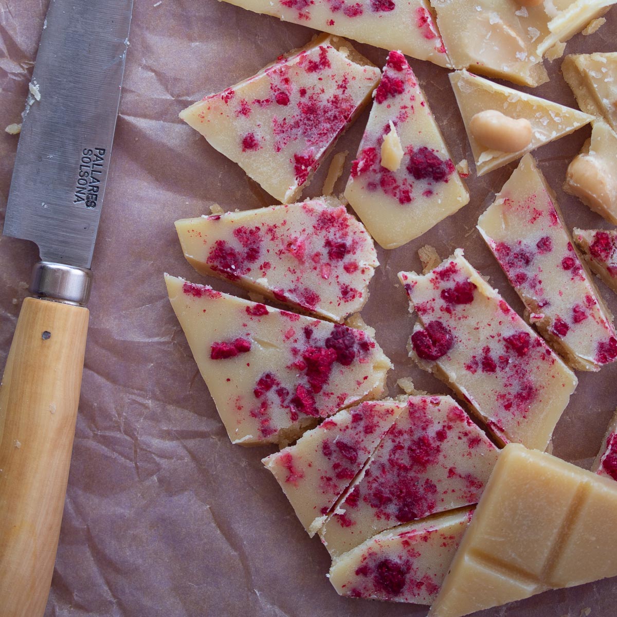 Vegan and Dairy Free white chocolate chopped in a close up with knife